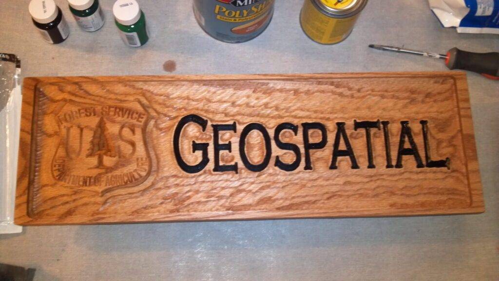 A wooden plaque reads 