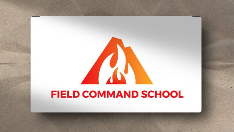 A logo with an orange and red mountain shape featuring a flame inside, above bold red text that reads "FIELD COMMAND SCHOOL" on a white rectangular background.