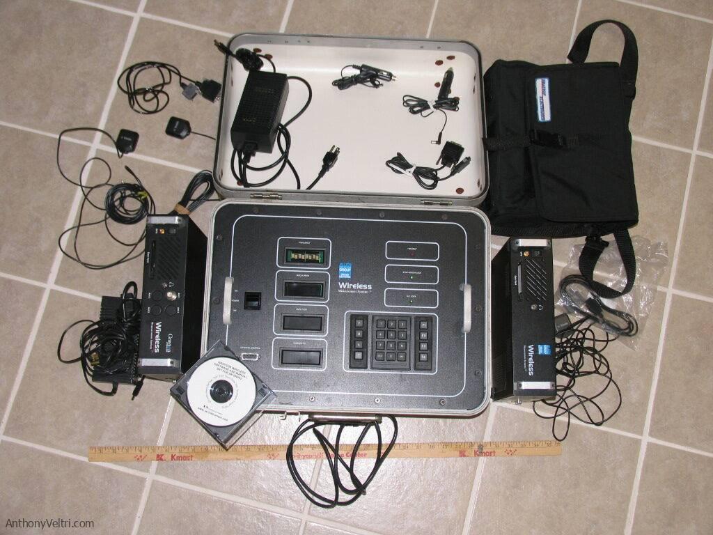 This display illustrates a wireless communications device and its accessories, suggesting a comprehensive equipment assessment scenario.